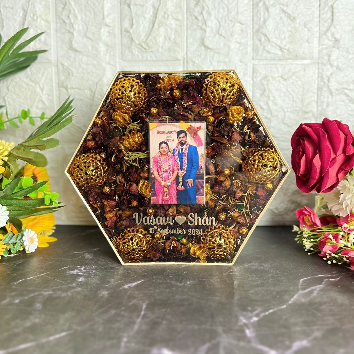 Wedding garland preserved in hexagonal wooden frame
