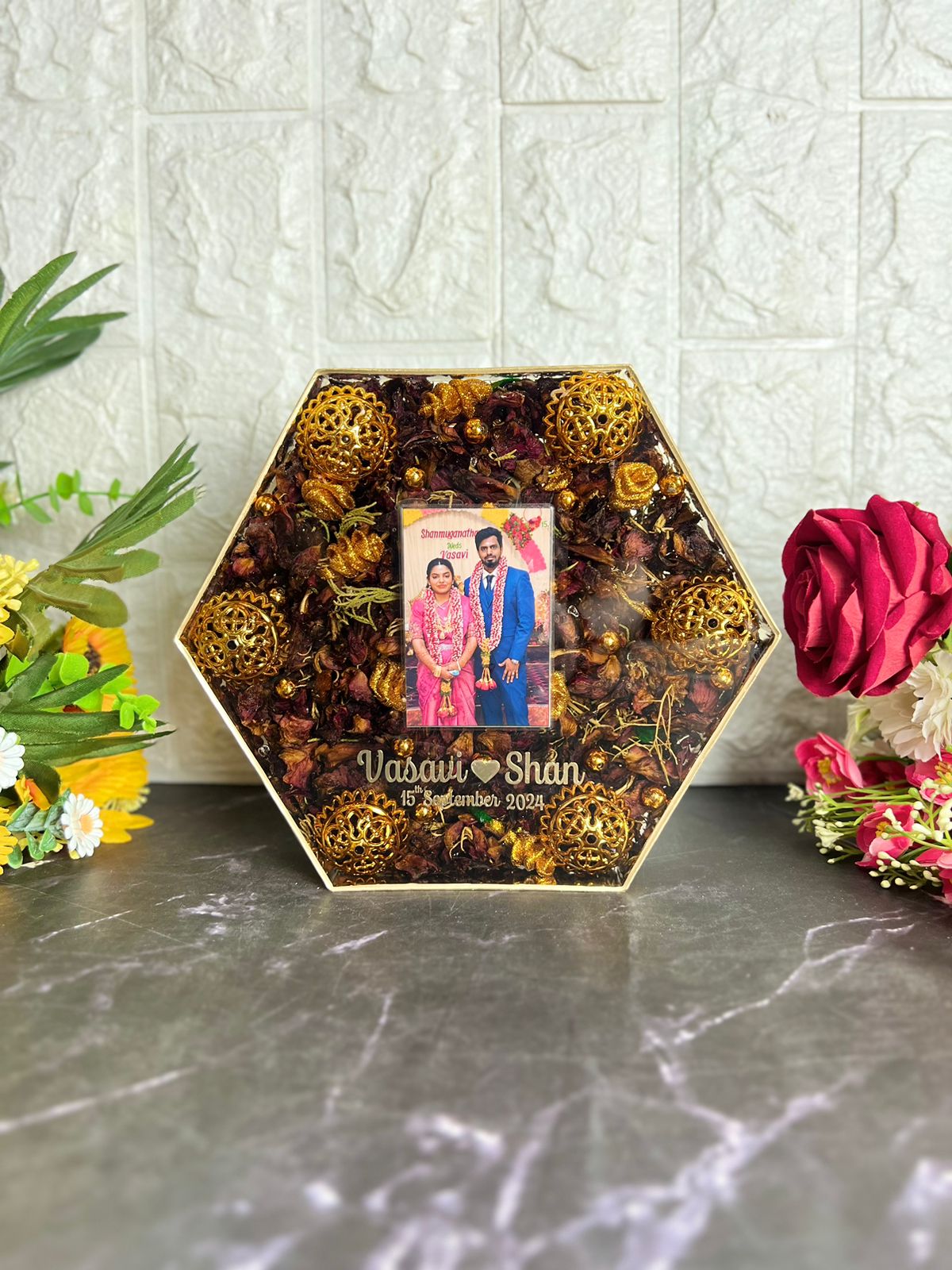 Wedding garland preserved in hexagonal wooden frame