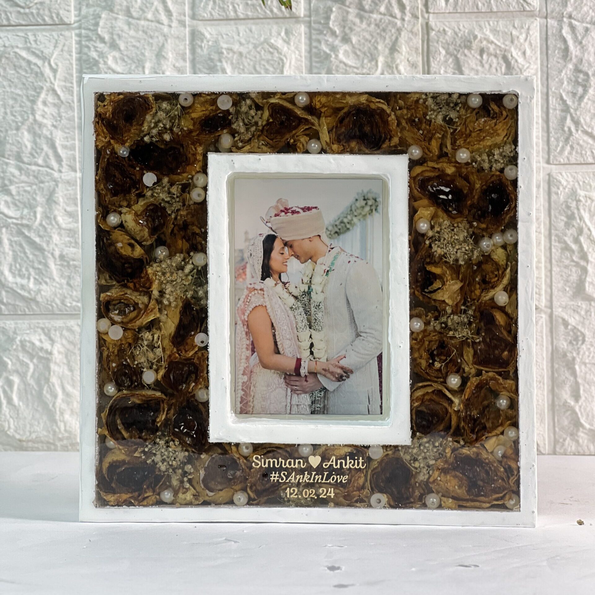 Teakwood resin frame with preserved wedding garland and photo