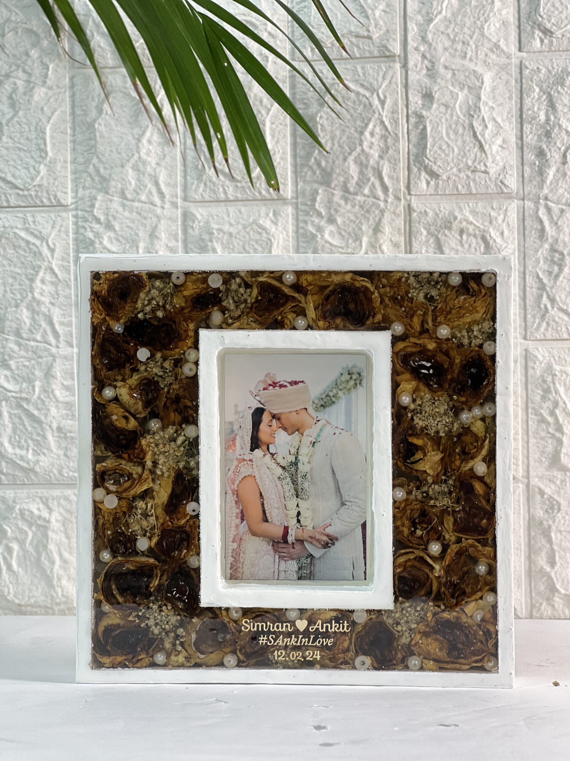 Teakwood resin frame with preserved wedding garland and photo