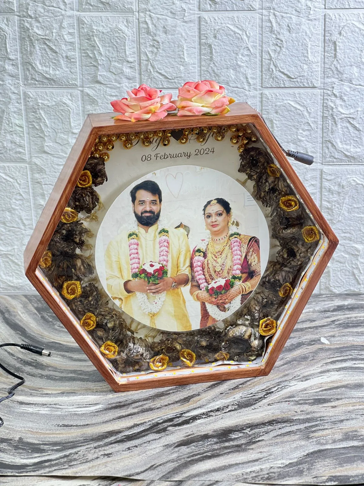 Hexagon teakwood varmala frame with couple photo, made from a real wedding varmala at our Jaipur studio
