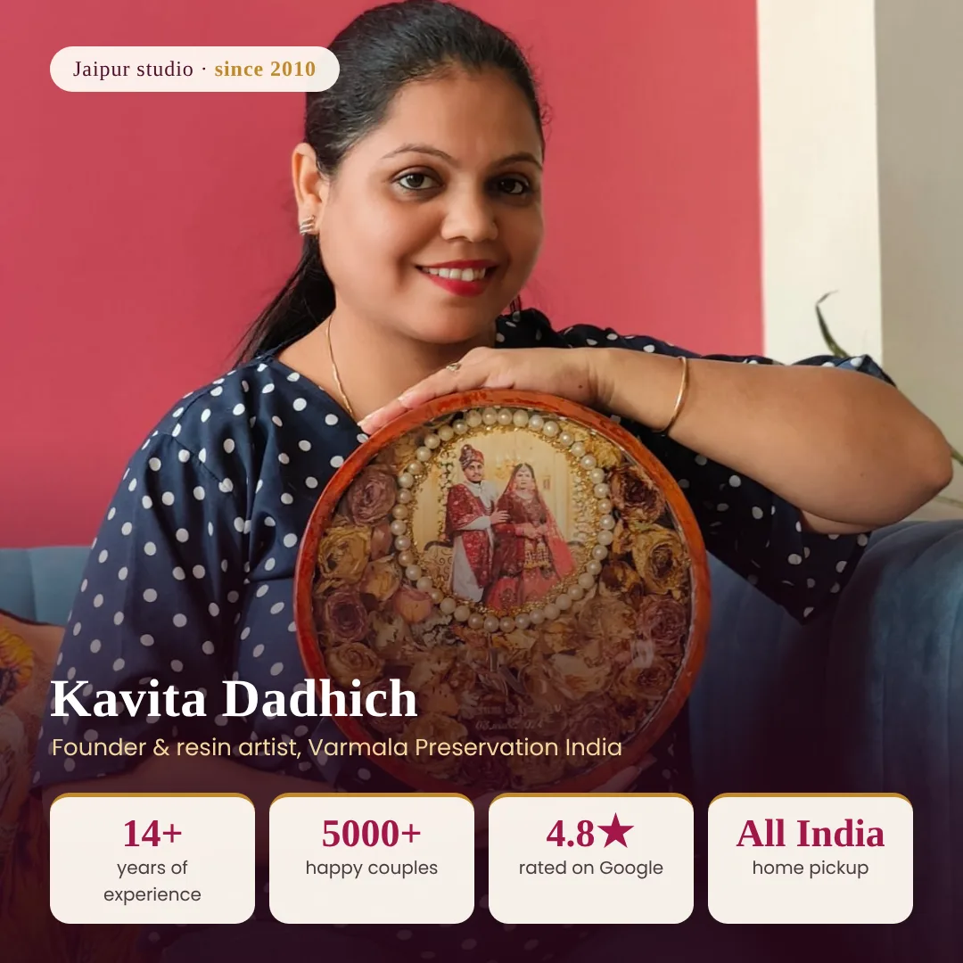 Kavita Dadhich, founder of Varmala Preservation India, holding a round varmala frame in her Jaipur studio
