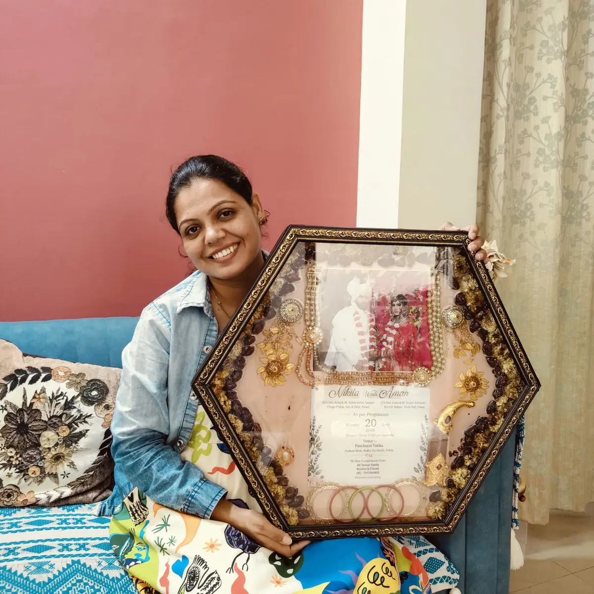 Kavita Dadhich with a hexagon varmala frame and wedding card