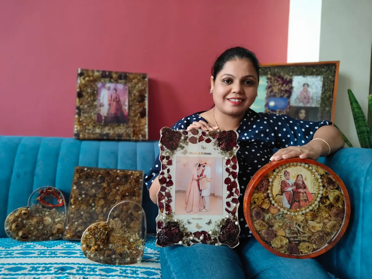 Kavita Dadhich with varmala frames and keepsakes at the Jaipur studio