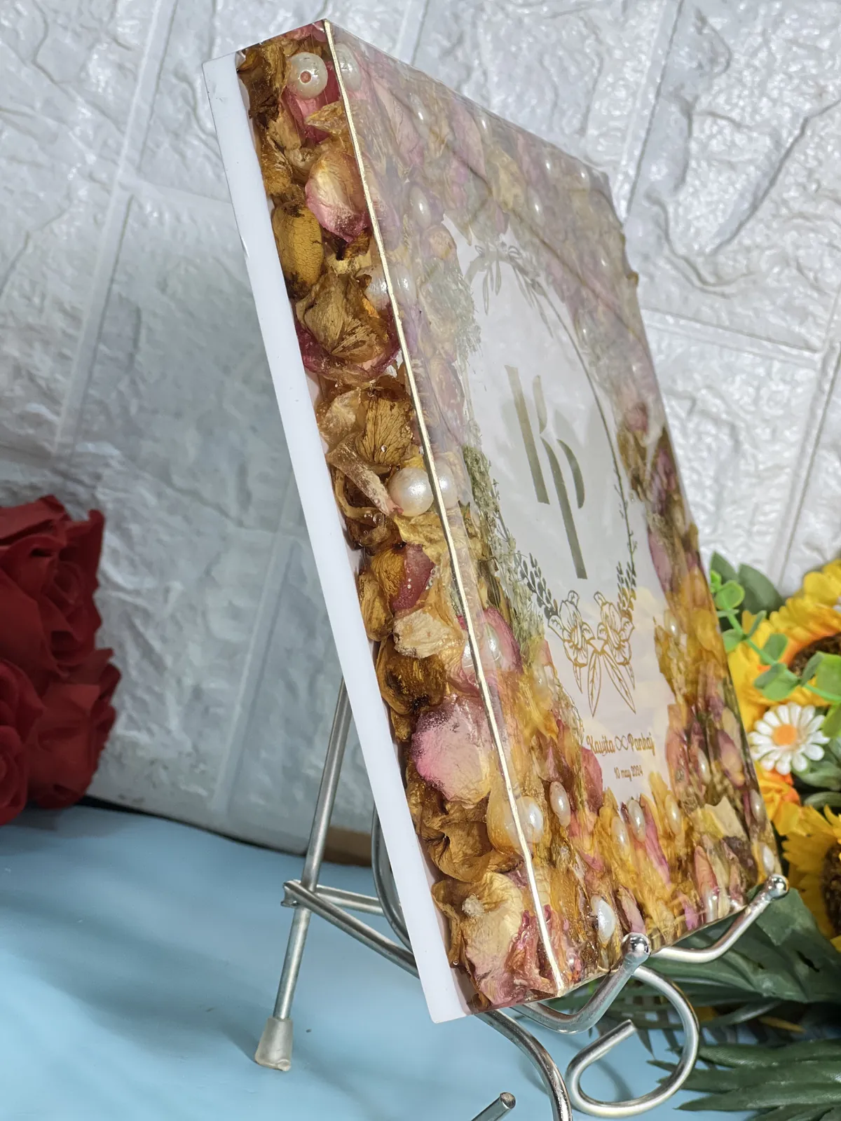 Close-up of dried roses and pearls set in resin, made from a real wedding varmala at our Jaipur studio
