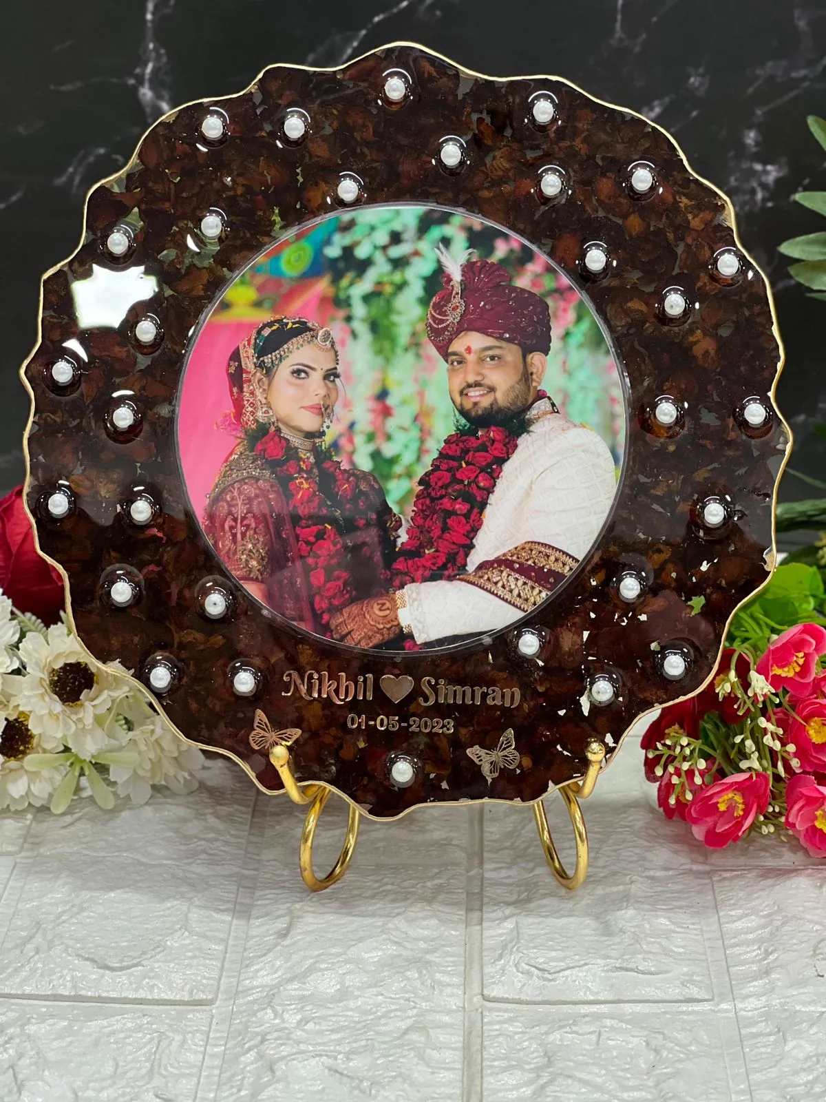 Round varmala frame with pearls and couple names, made from a real wedding varmala at our Jaipur studio